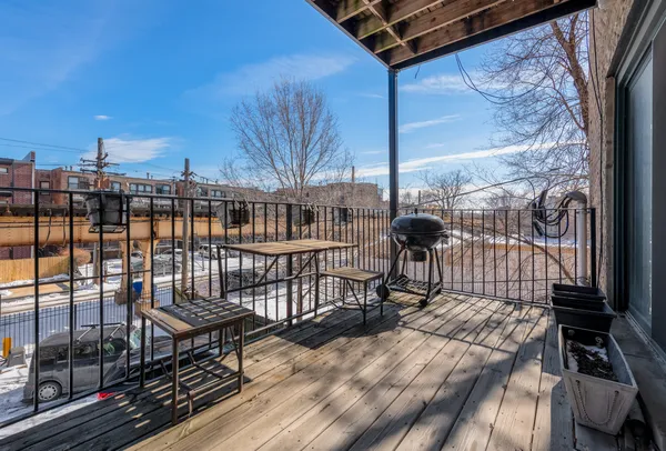 a view of a balcony with wooden floor
