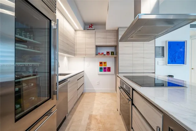 a kitchen with a sink dishwasher stove and cabinets