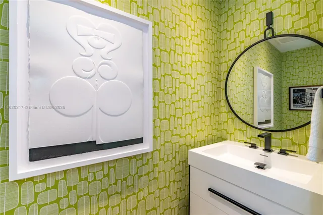 a bathroom with a sink mirror and vanity