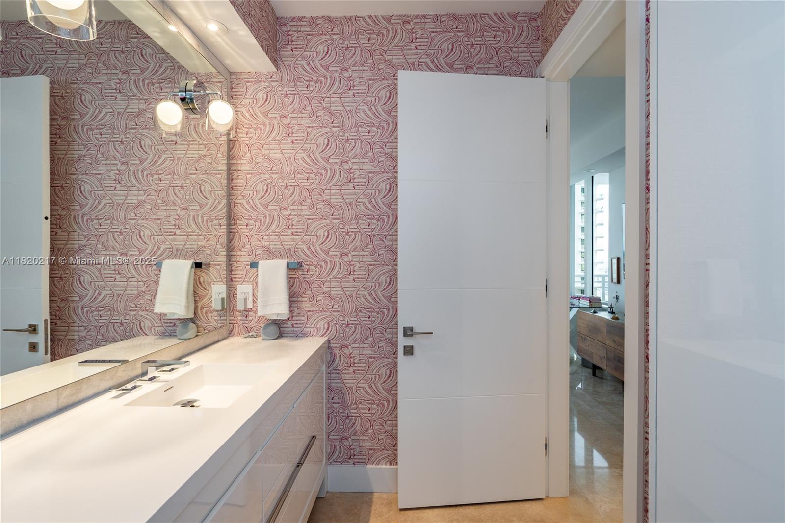 901 Brickell Key Boulevard, Unit 2602 Miami, FL 33131 - Photo 19 of 29 a bathroom with a sink vanity and a mirror