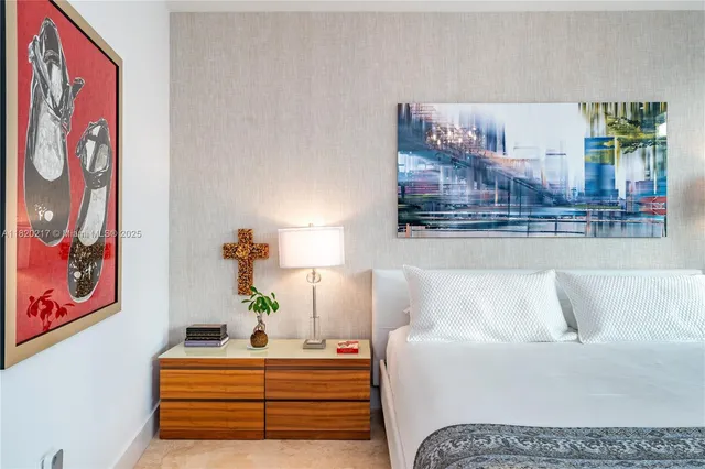 a bedroom with a bed and wall painting