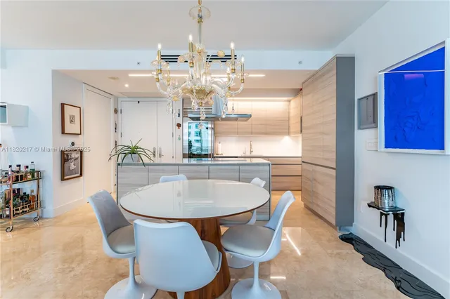 a dining room with furniture a chandelier and wooden floor
