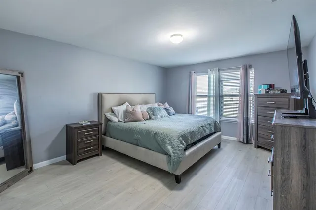 a bedroom with a bed and a television