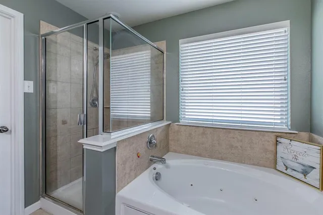 a bathroom with a bathtub and a shower