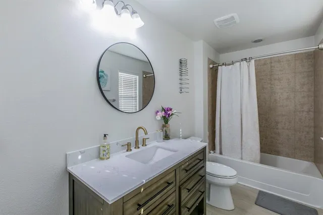 a bathroom with a toilet a sink and a mirror