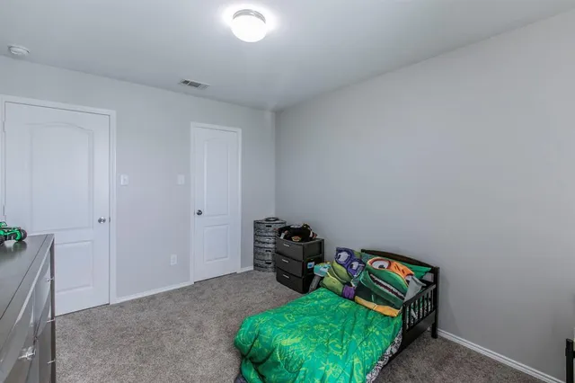 a bedroom with a bed and a mirror