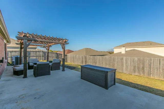 a roof deck with couches and umbrella