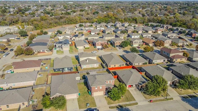 an aerial view of residential houses with outdoor space