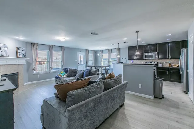 a living room with furniture and a kitchen