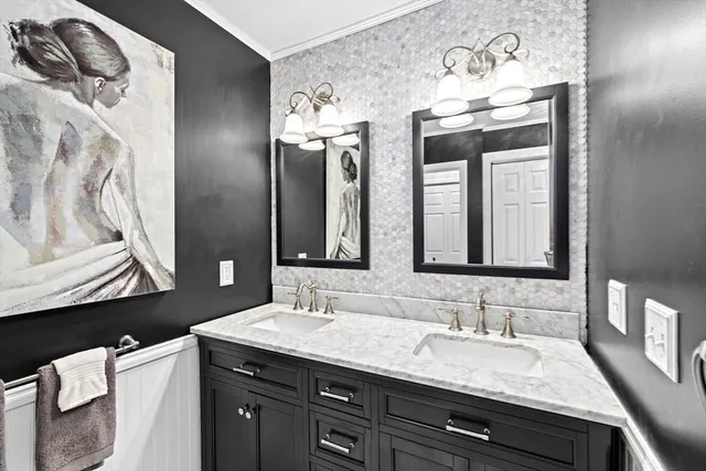 a bathroom with a granite countertop sink vanity and mirror