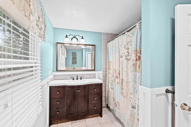 a bathroom with a sink a mirror and a shower