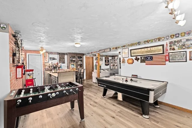a room with furniture pool table and flat screen tv