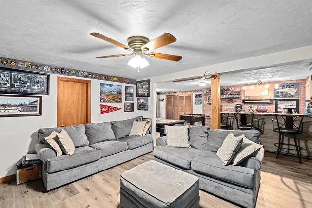 a living room with furniture ceiling fan and a rug