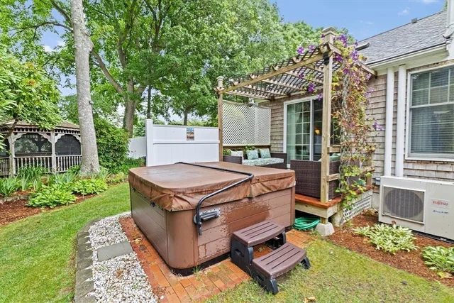 front view of a house with a yard table and chairs