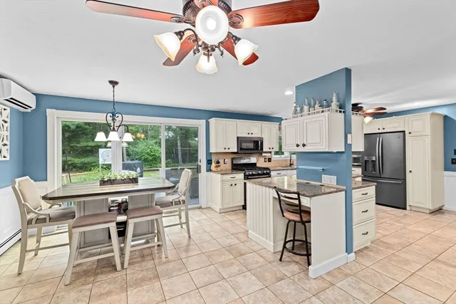 a living room with stainless steel appliances kitchen island granite countertop furniture and a view of kitchen