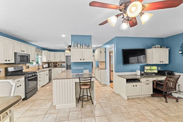 a kitchen with cabinets a sink and appliances