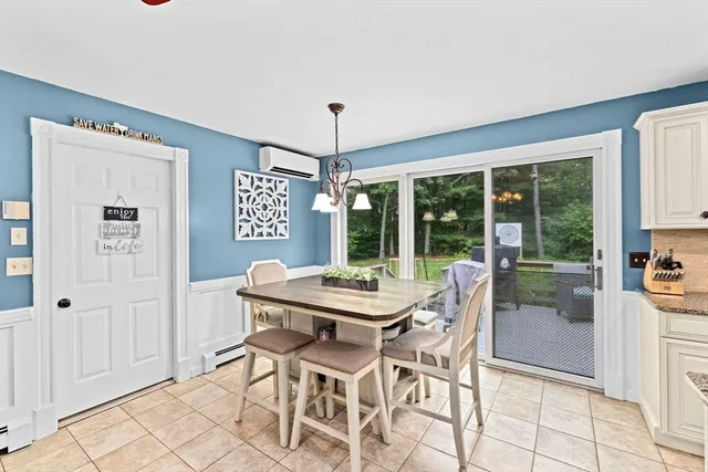 a dining room with furniture a chandelier and window
