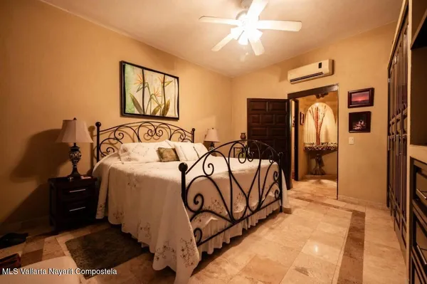 a bedroom with a bed and a chandelier