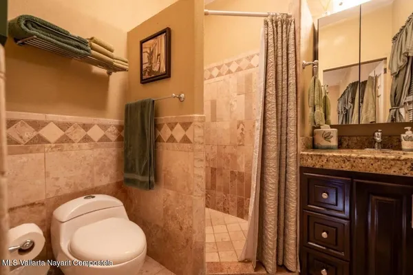 a bathroom with a toilet a sink and shower