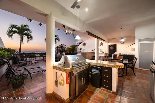 a view of a kitchen with kitchen island granite countertop lots of counter top space
