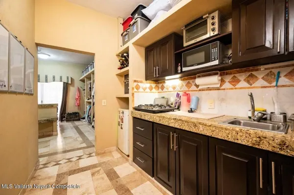 a kitchen with stainless steel appliances granite countertop a sink and cabinets