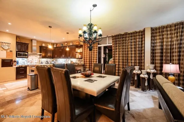 a view of a dining room with furniture and chandelier