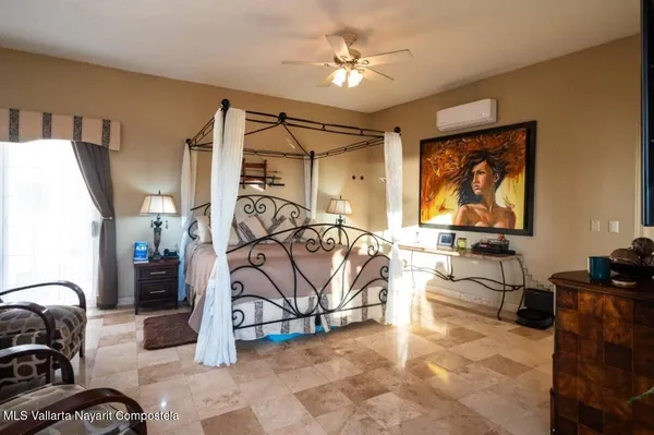 a view of a livingroom with furniture and a ceiling fan