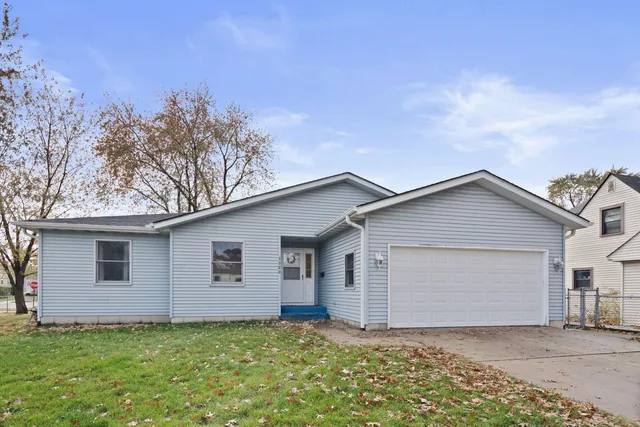 a view of a house with a yard and garage