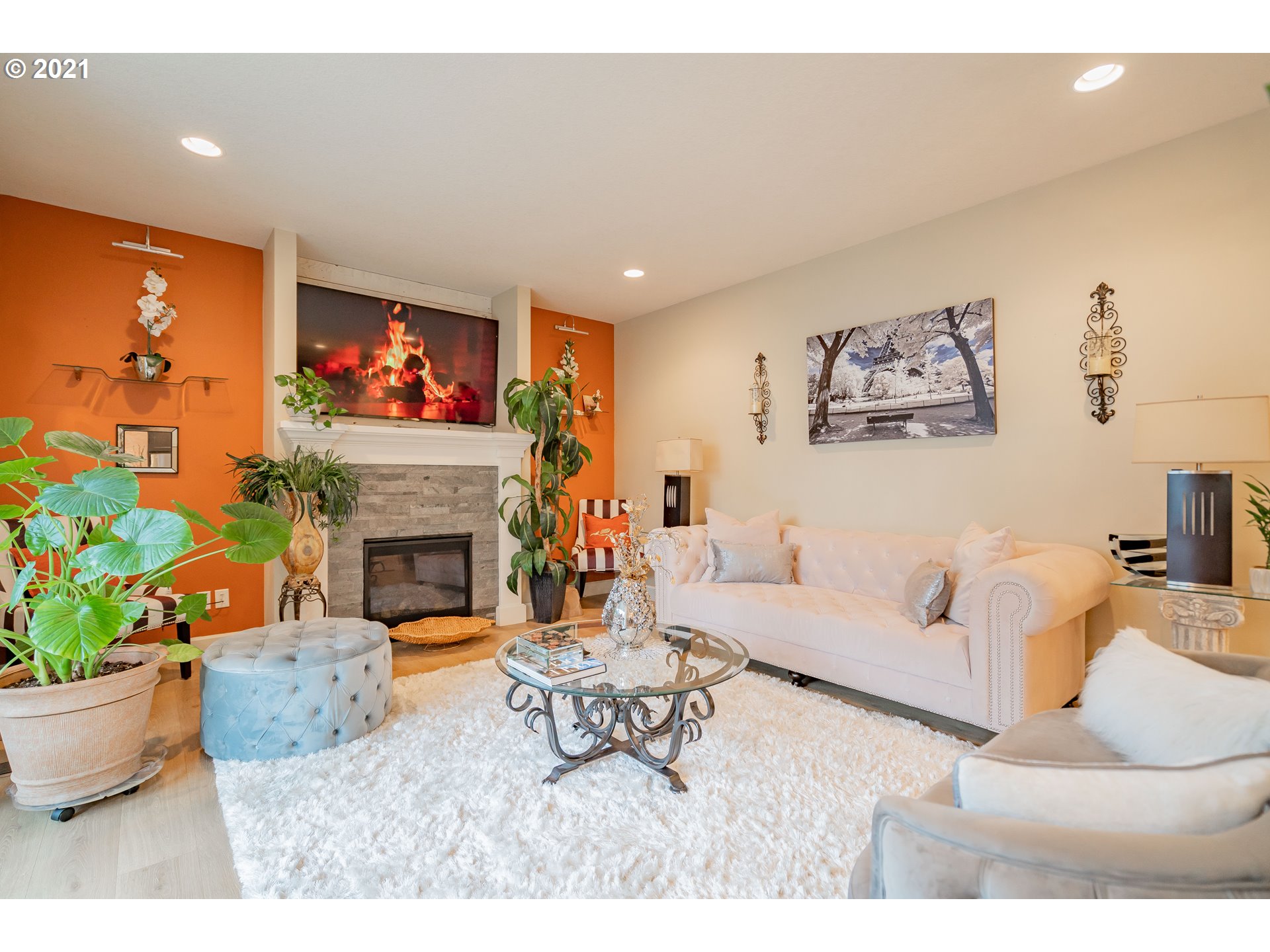 1248 South Quail Run Place Ridgefield, WA 98642 - Photo 11 of 28 a living room with furniture a fireplace and a flat screen tv