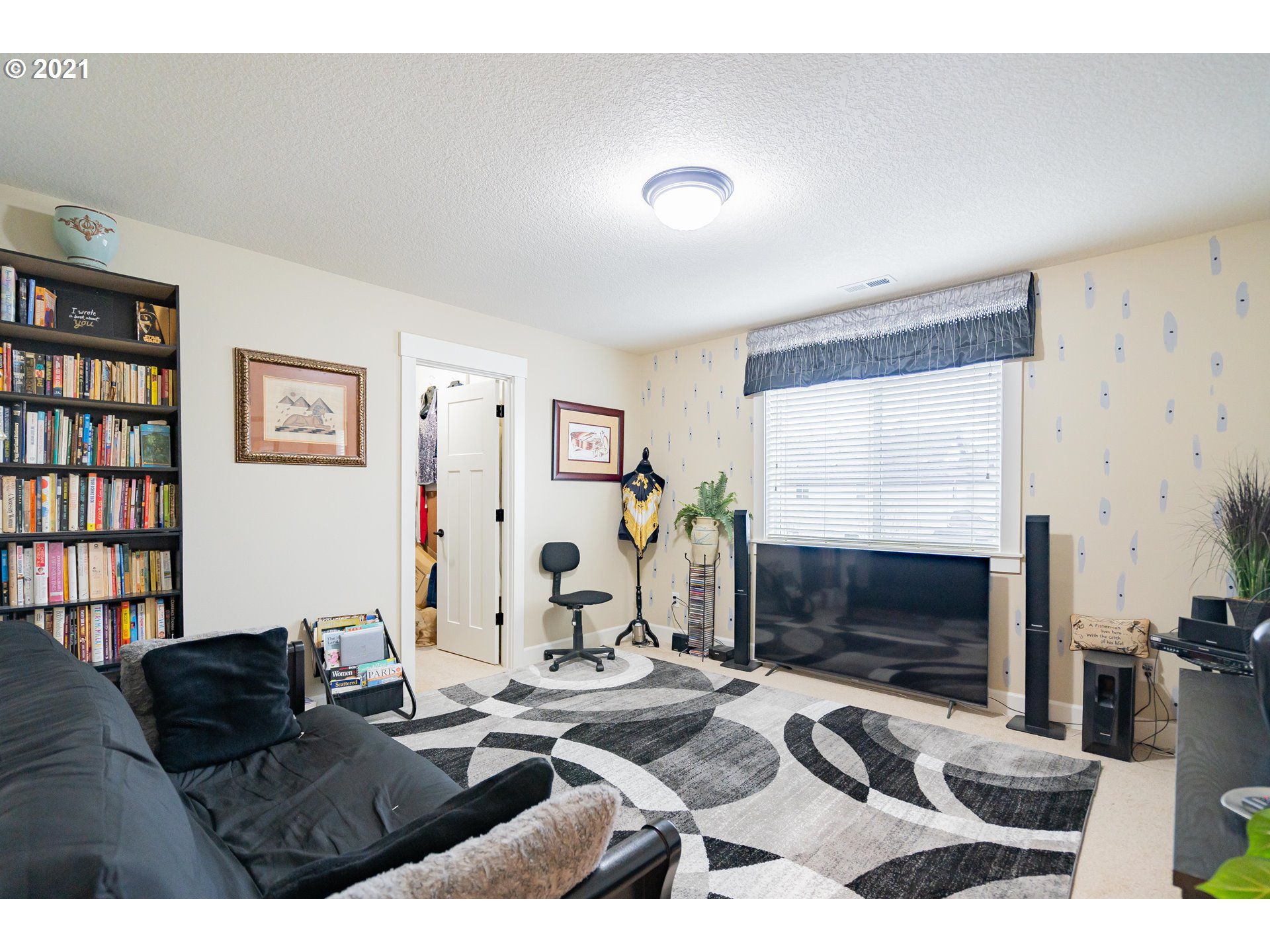 1248 South Quail Run Place Ridgefield, WA 98642 - Photo 13 of 28 a living room with furniture a flat screen tv and a fireplace