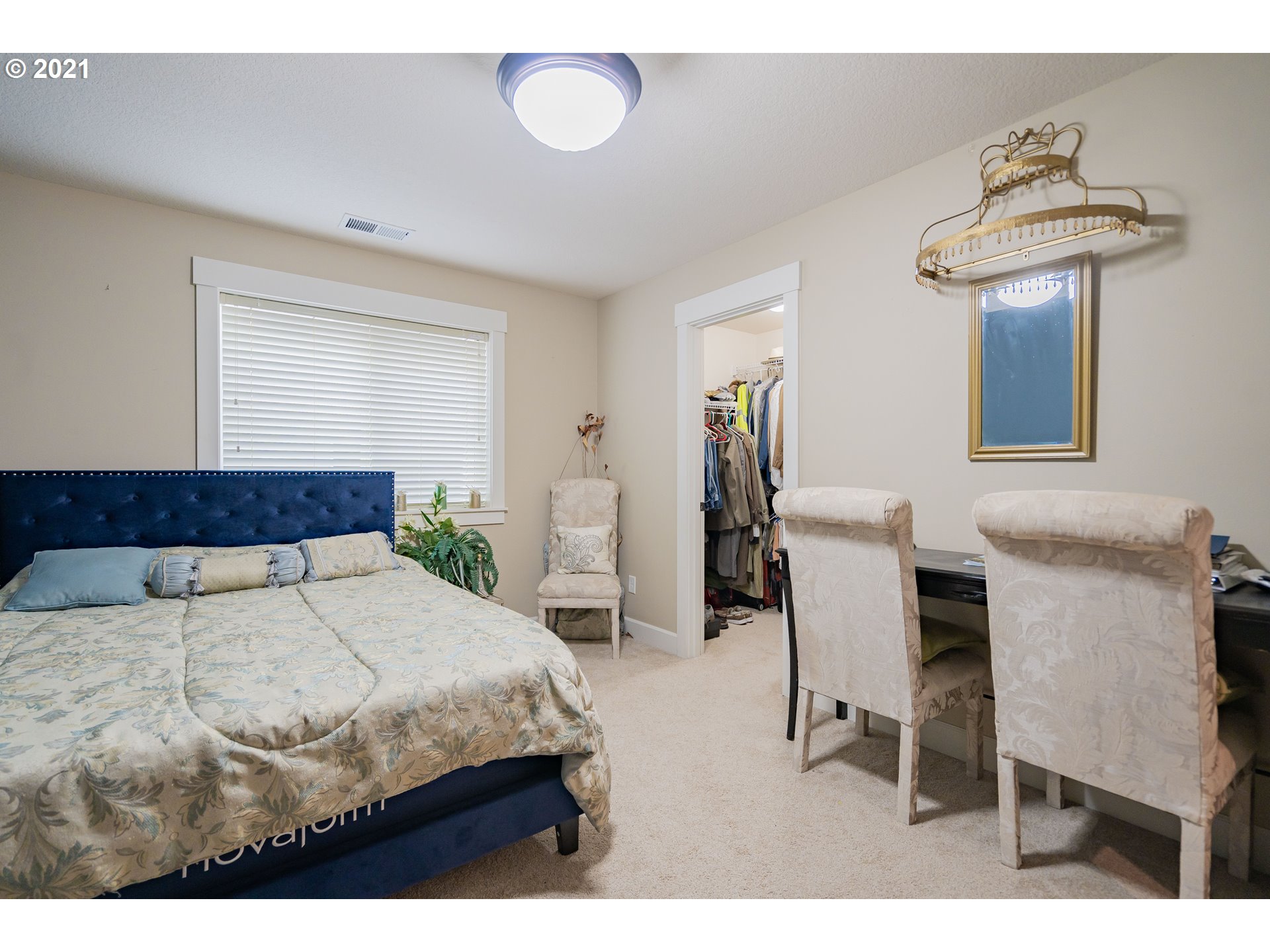 1248 South Quail Run Place Ridgefield, WA 98642 - Photo 16 of 28 a bedroom with a bed and a chandelier