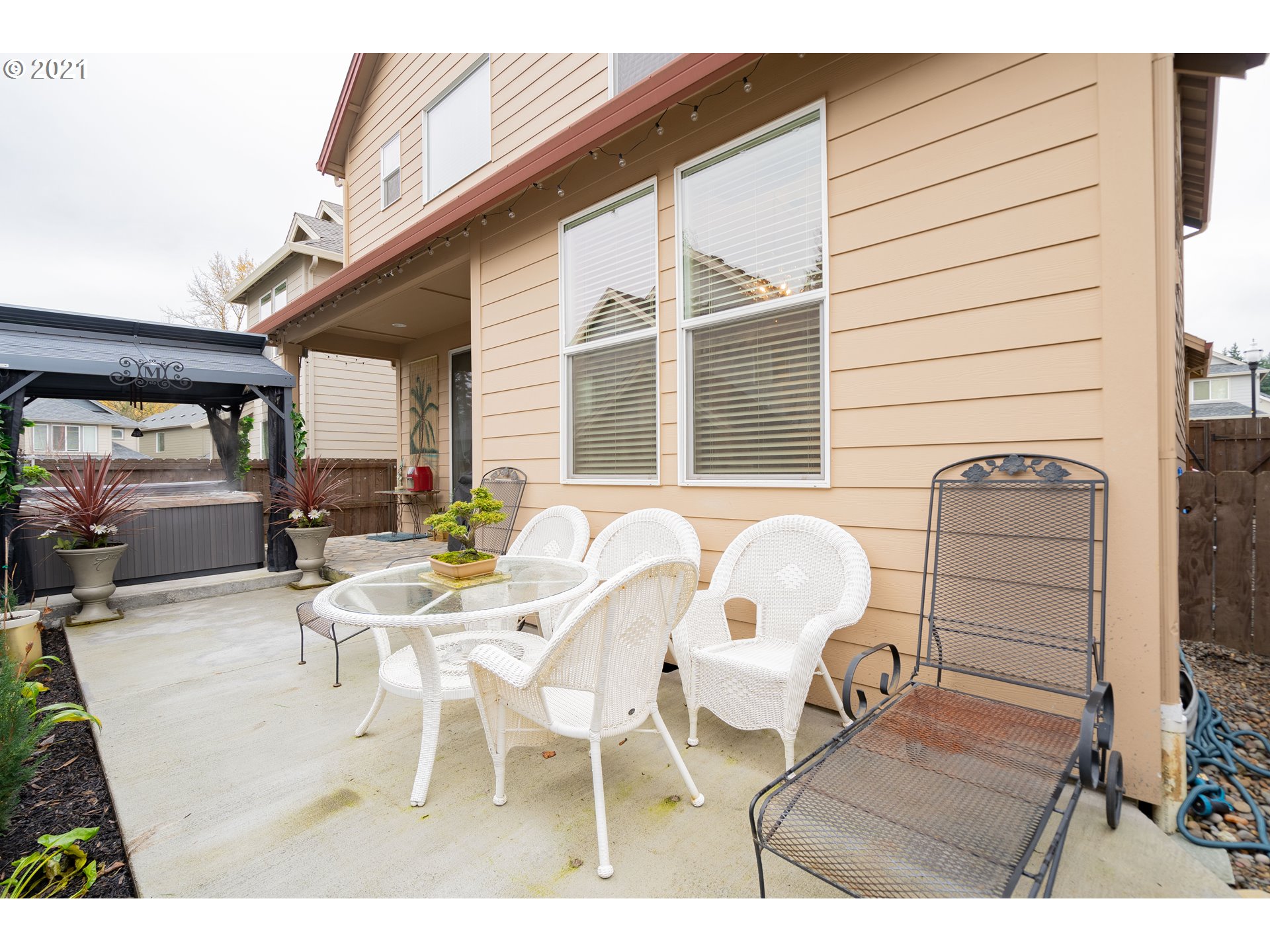 1248 South Quail Run Place Ridgefield, WA 98642 - Photo 27 of 28 a view of a patio with table and chairs and potted plants