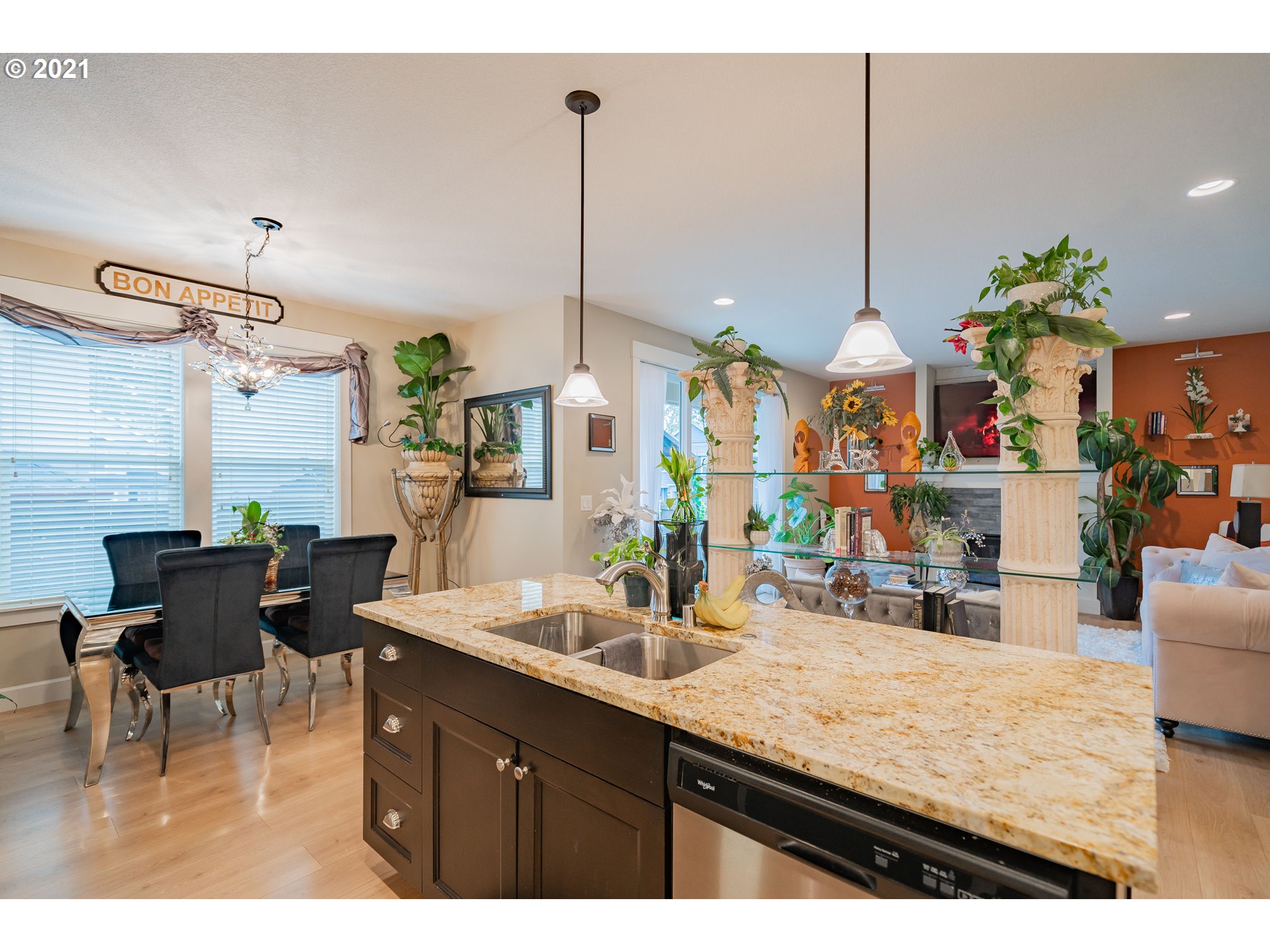 1248 South Quail Run Place Ridgefield, WA 98642 - Photo 7 of 28 a kitchen with stainless steel appliances kitchen island granite countertop a table and chairs in it