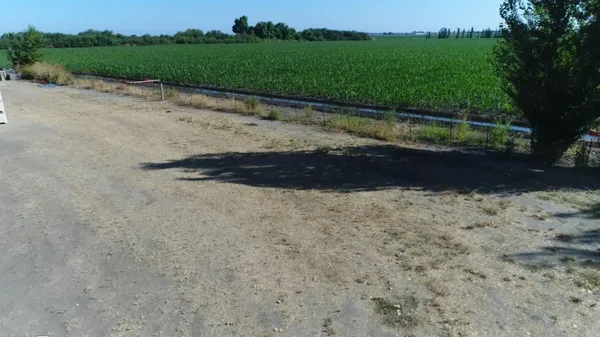 a bench sitting in middle of a field next to a road