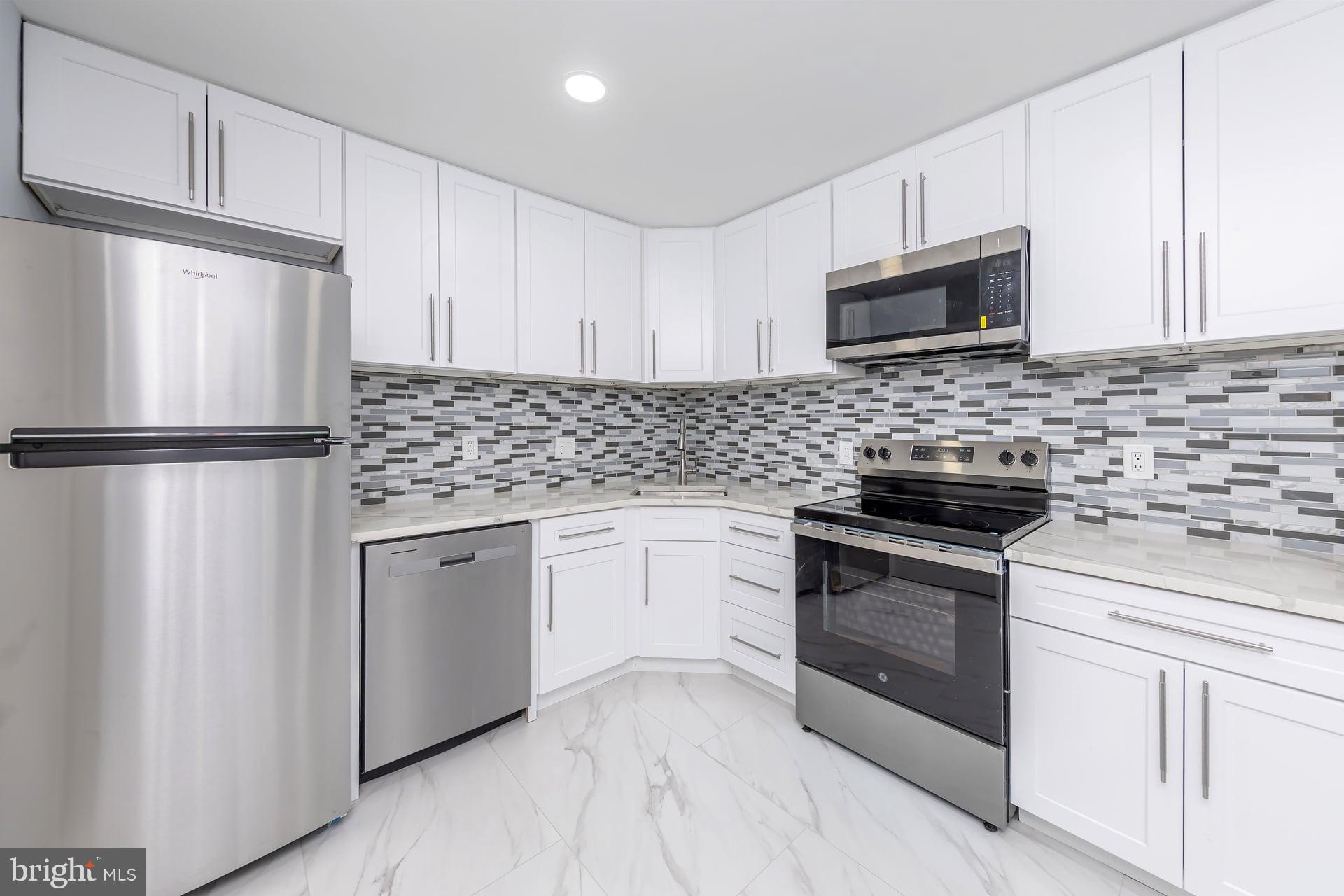18 Brighton Place Sewell, NJ 08080 - Photo 12 of 19 a kitchen with white cabinets stainless steel appliances and sink
