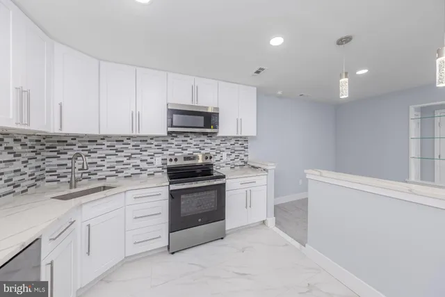 a bathroom with a granite countertop sink a toilet and shower