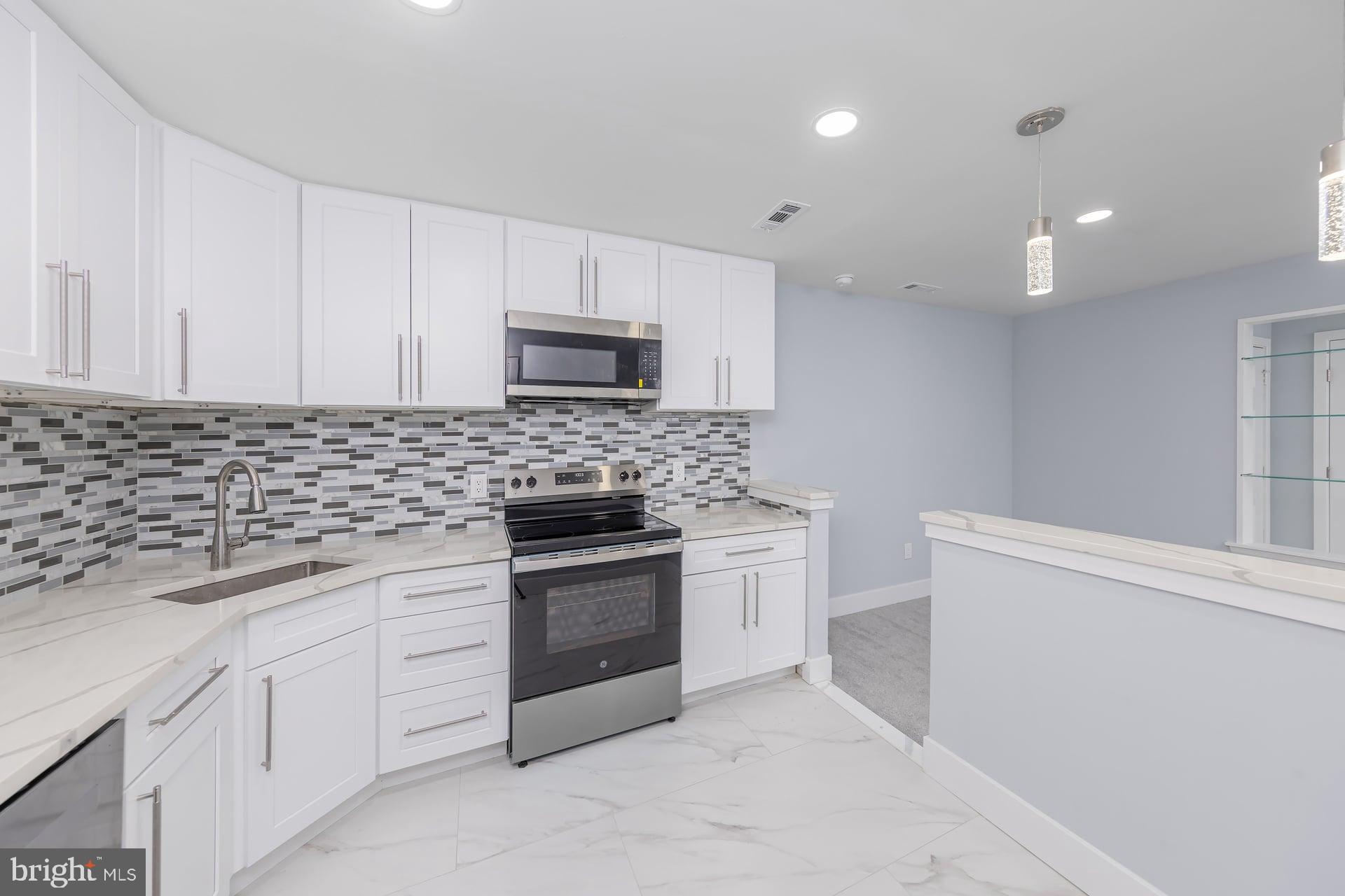 18 Brighton Place Sewell, NJ 08080 - Photo 13 of 19 a kitchen with granite countertop white cabinets and stainless steel appliances