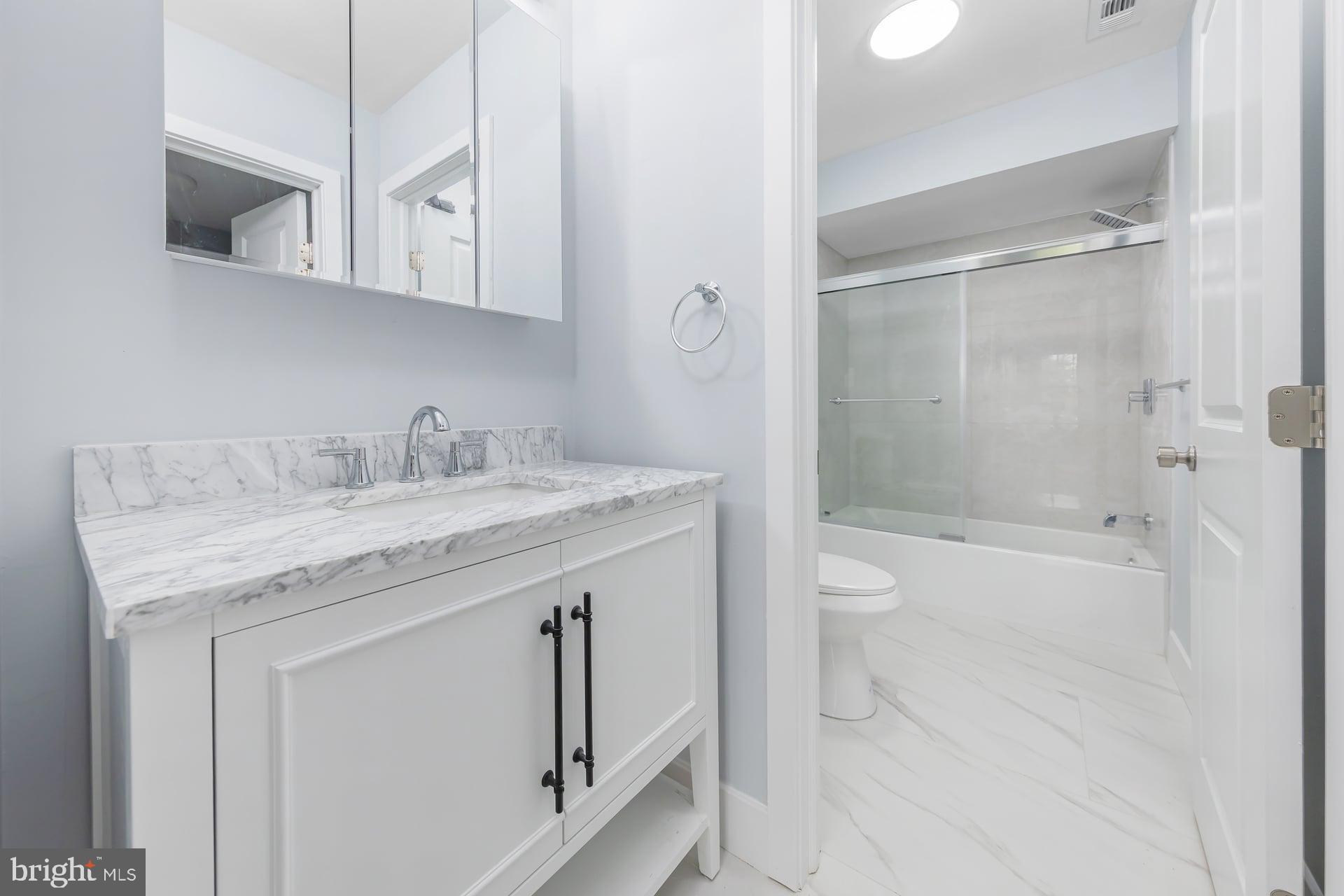 18 Brighton Place Sewell, NJ 08080 - Photo 15 of 19 a bathroom with a granite countertop sink a toilet and shower