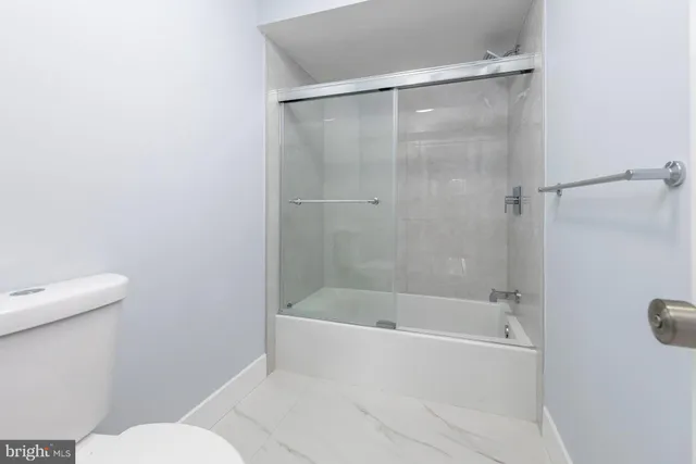 a bathroom with a sink toilet and a mirror