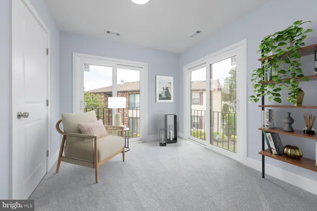 a living room with furniture and a floor to ceiling window
