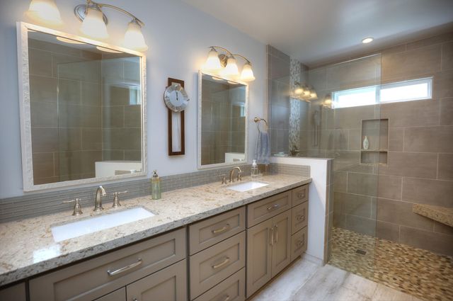 a bathroom with double sink and a mirror