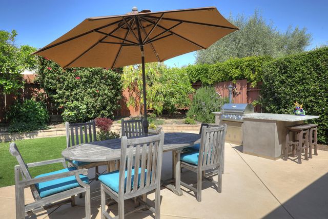 a view of a patio with a table chairs and a umbrella