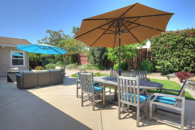 a view of a patio with furniture and a umbrella