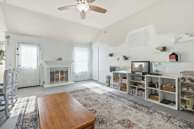 a living room with furniture a fireplace and a book shelf