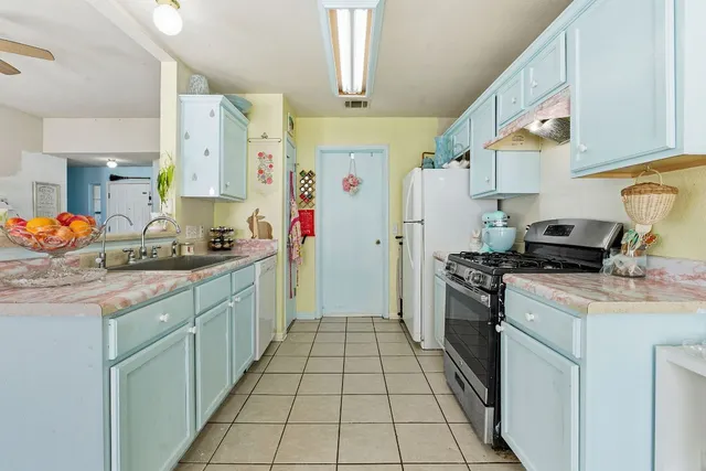 a kitchen with stainless steel appliances a stove a refrigerator and cabinets