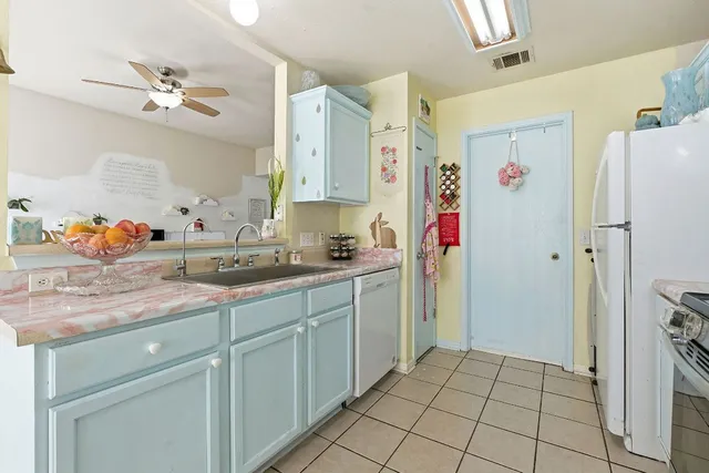 a kitchen with a stove a sink and cabinets