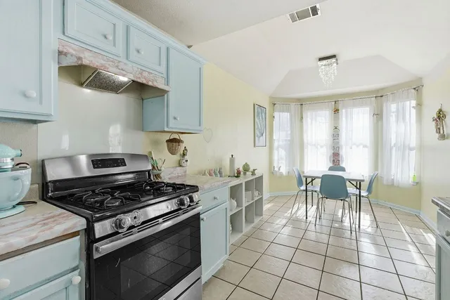 a kitchen with sink cabinets and dining table