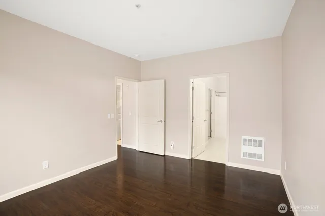 a view of an empty room with wooden floor