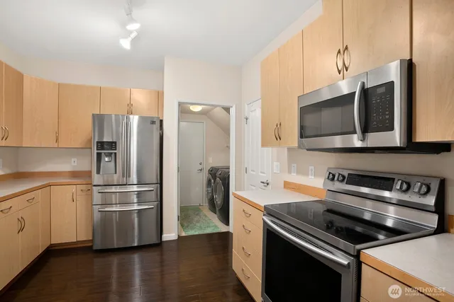 a kitchen with stainless steel appliances and wooden cabinets