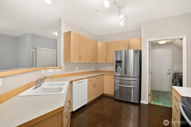 a kitchen with a refrigerator sink and stove